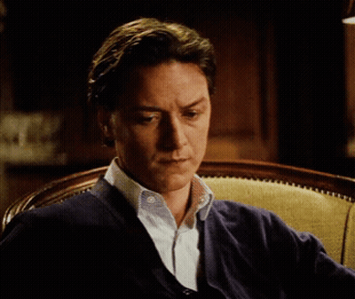 Man In Blue Sweater Sitting Seriously GIF