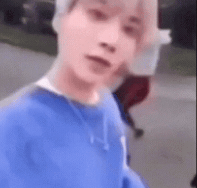 Man In Blue Sweater Taking Selfie While Walking GIF
