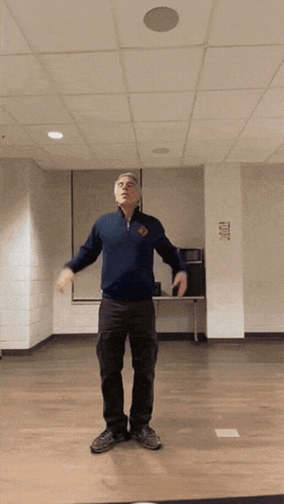 Man In Blue Sweater With Exit Sign GIF