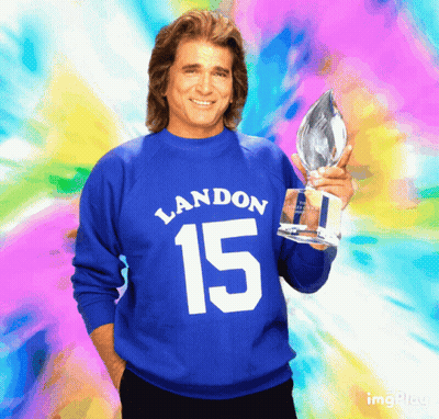 Man In Blue Sweater With Number 15 Holding Trophy GIF