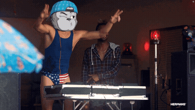 Man In Blue Tank Top And Red White Blue Trunks Dancing At Brother Keyboard GIF