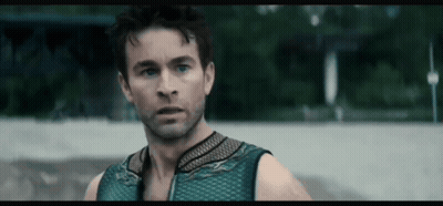 Man In Blue Tank Top Looking At Camera GIF