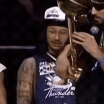 Man In Blue Thunder Jersey Holding Trophy GIF