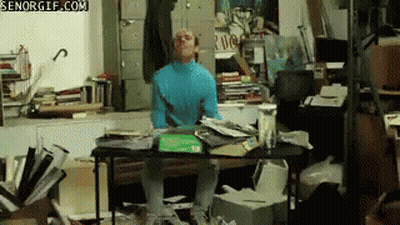 Man In Blue Turtleneck At Messy Desk Senorgif.com GIF