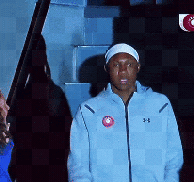 Man In Blue Under Armour Jacket In Front Of Stairs GIF