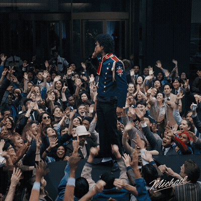 Man In Blue Uniform Standing Before Crowd With Name Michael GIF