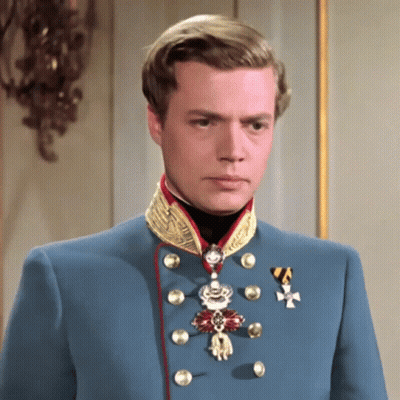 Man In Blue Uniform With Medal And Cross GIF