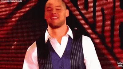 Man In Blue Vest And White Shirt On Red Background GIF
