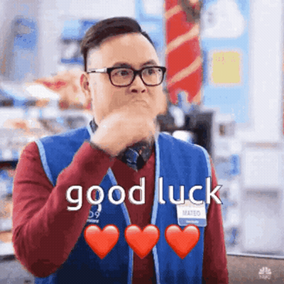 Man In Blue Vest Glasses Saying Good Luck Hearts GIF