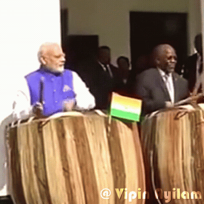 Man In Blue Vest Holding Microphone, Man In Suit Holding Flag GIF