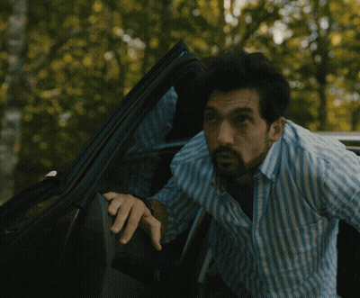 Man In Blue White Striped Shirt Looking Out Car Window GIF