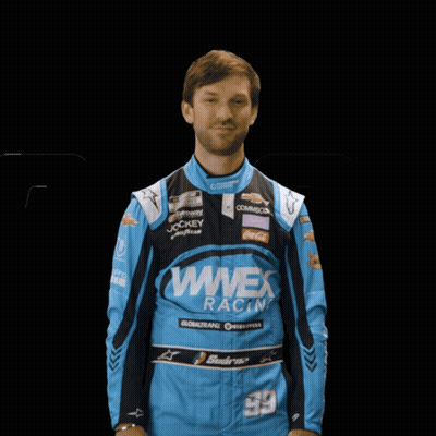 Man In Blue Wwex Racing Jacket Raises Hand GIF