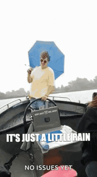 Man In Boat Holding Umbrella GIF