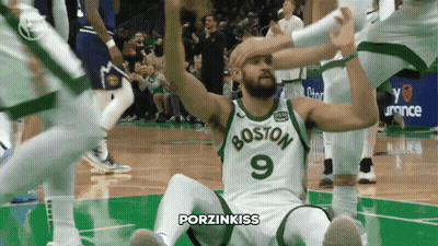 Man in Boston Jersey Sitting on Floor