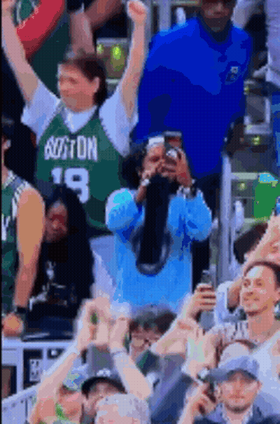 Man in Boston Jersey Taking Picture of Crowd