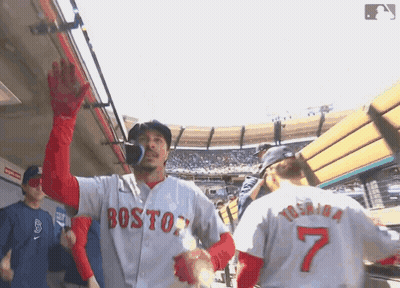 Man In Boston Jersey Waves To Another Man GIF
