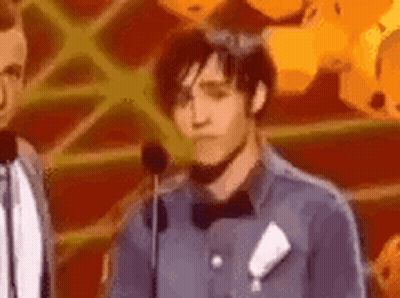Man In Bow Tie Making Face At Microphone GIF