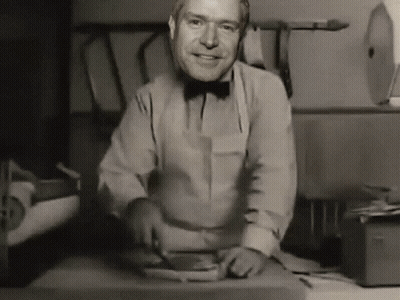 Man In Bow Tie Smiling While Cutting Meat GIF