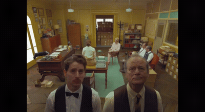 Man In Bow Tie Standing Before Crowd GIF