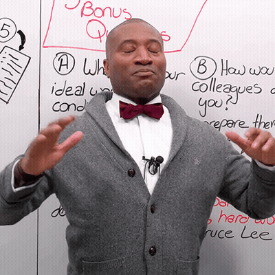 Man In Bow Tie With Bonus Questions Board GIF