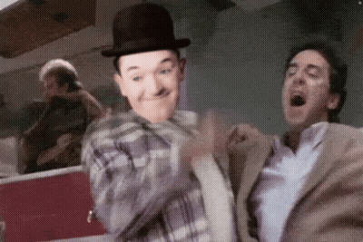 Man In Bowler Hat Next To Man In Suit GIF