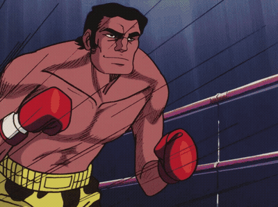 Man in Boxing Gloves and Yellow Shorts Standing in Ring