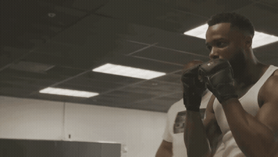 Man In Boxing Gloves In Dark Room GIF