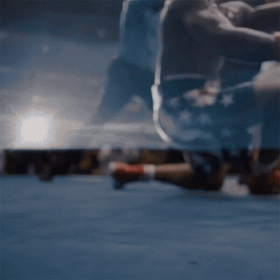 Man In Boxing Gloves Laying On Ground In Ring GIF