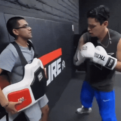 Man In Boxing Gloves Next To Man With Vest Saying Ure GIF