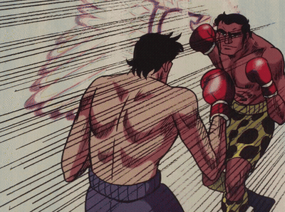 Man in Boxing Gloves Throws Punch at Another Man