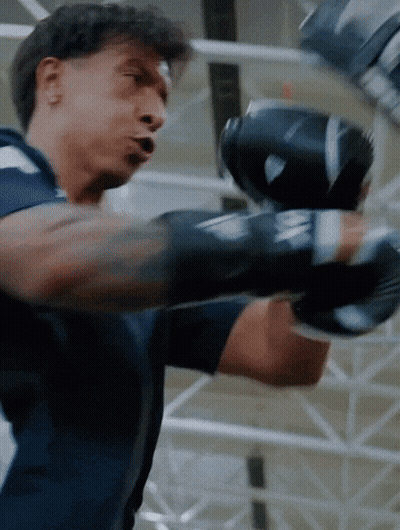 Man In Boxing Gloves With Letter E On Cuffs GIF