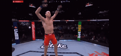 Man In Boxing Ring With Arms Up Saying Take GIF
