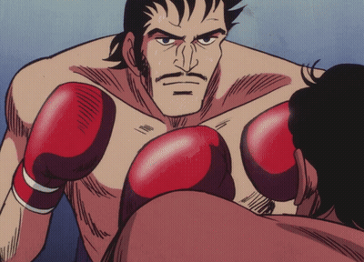 Man in Boxing Ring With Red Gloves