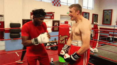 Man In Boxing Ring With Sugar Ray Bag GIF