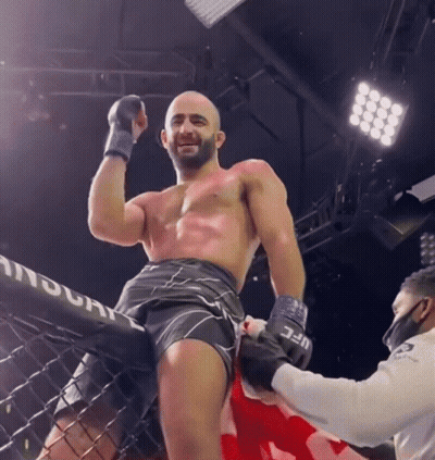 Man in Boxing Ring With UFC Logo Shorts