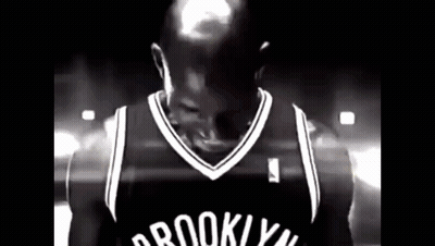 Man In Brooklyn Nets Jersey In Dark Room GIF