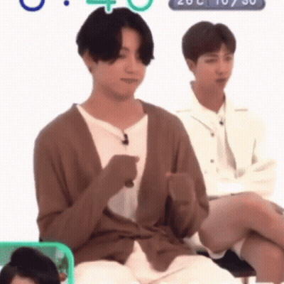 Man In Brown Cardigan Sitting GIF