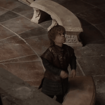 Man In Brown Coat Standing Before Stone Bench With Sword GIF