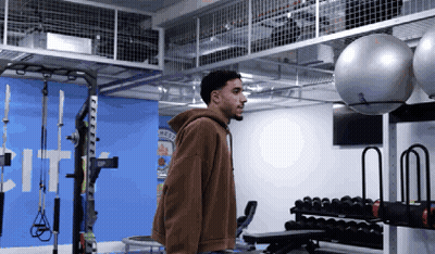 Man In Brown Hoodie In Gym GIF