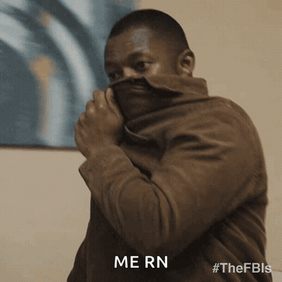 Man In Brown Jacket Covering Face With Jacket Saying Mern GIF