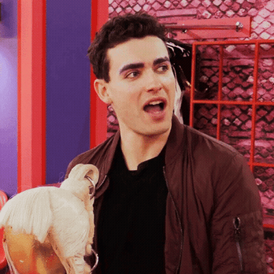 Man In Brown Jacket Holding Mannequin GIF