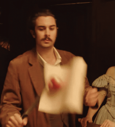 Man In Brown Jacket Holding Paper GIF