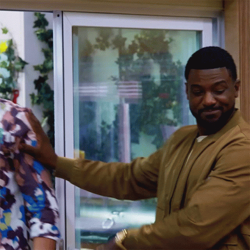 Man In Brown Jacket Holding Woman's Arm GIF