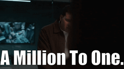 Man In Brown Jacket In Front Of A Million To One Sign GIF