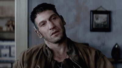Man In Brown Jacket Sitting In Living Room GIF