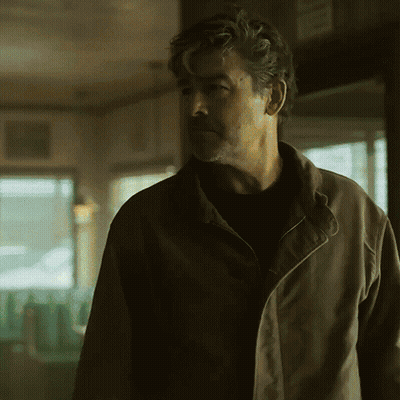 Man In Brown Jacket Standing In Room GIF