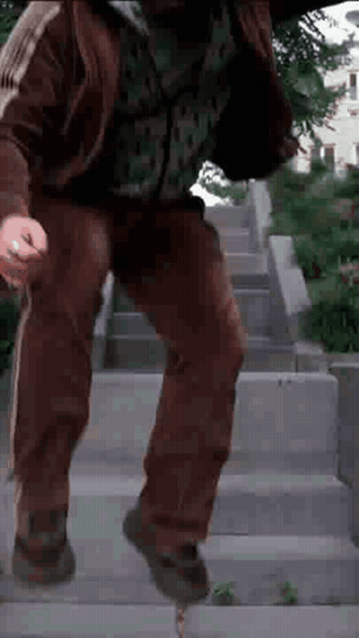 Man In Brown Jacket Walking Down Stairs GIF