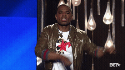 Man In Brown Jacket With Red Star Dancing In Front Of BET Logo GIF