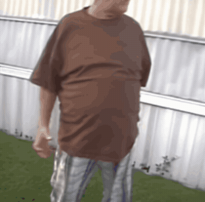 Man In Brown Shirt And Plaid Shorts GIF