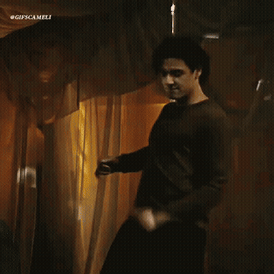 Man In Brown Shirt Dancing Before Curtain #Gifscamelli GIF